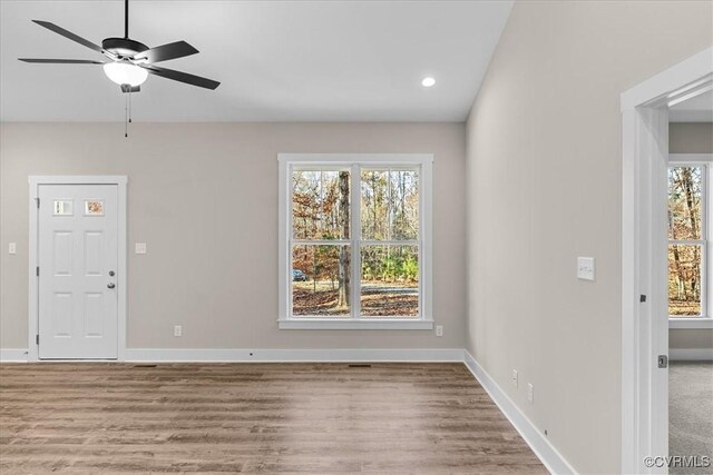 interior space with ceiling fan, a healthy amount of sunlight, and light wood-type flooring