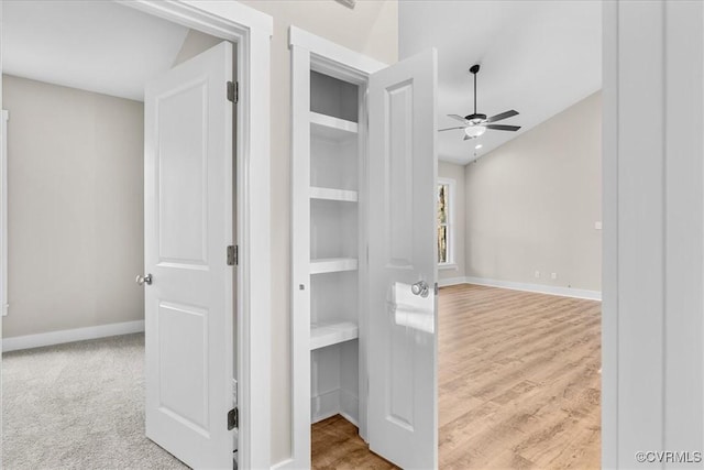 corridor with light hardwood / wood-style flooring