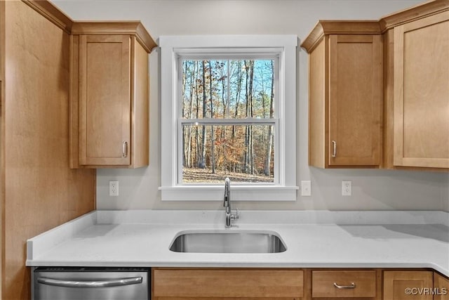 kitchen featuring dishwasher, light stone countertops, and sink