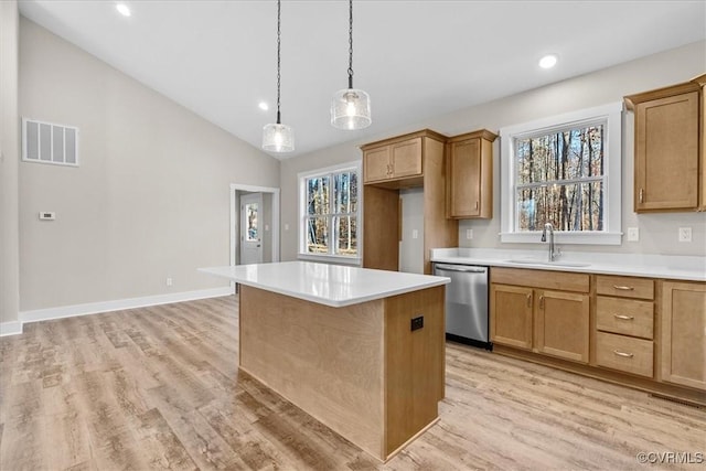 kitchen with decorative light fixtures, sink, a center island, stainless steel dishwasher, and light hardwood / wood-style floors