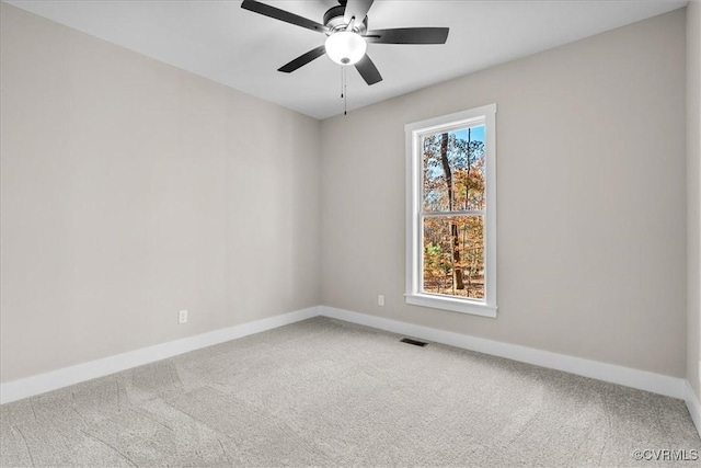 unfurnished room with ceiling fan and carpet floors