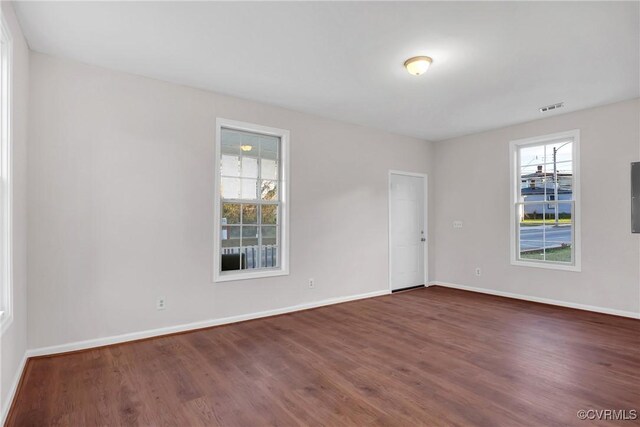 spare room with dark hardwood / wood-style floors