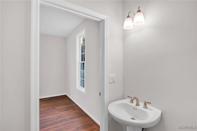 bathroom with hardwood / wood-style flooring and sink