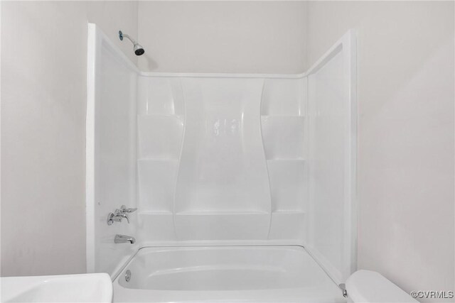 bathroom with shower / bathing tub combination and toilet