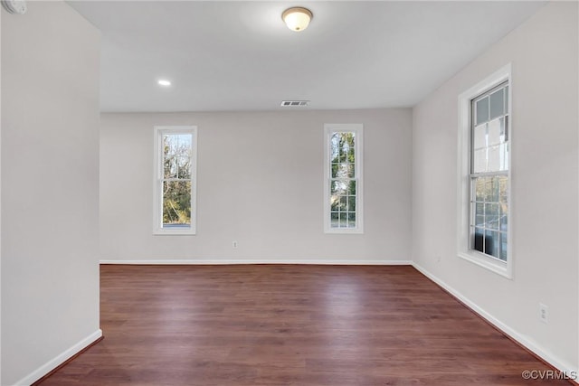 unfurnished room featuring dark hardwood / wood-style flooring