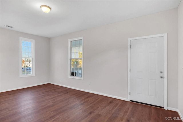 empty room featuring dark hardwood / wood-style flooring