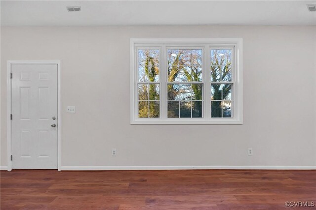 empty room with dark wood-type flooring