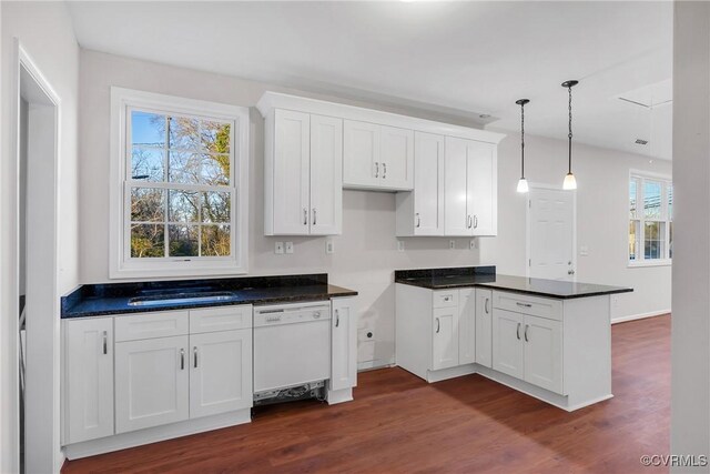 kitchen with white cabinets, dark wood-type flooring, sink, pendant lighting, and dishwasher