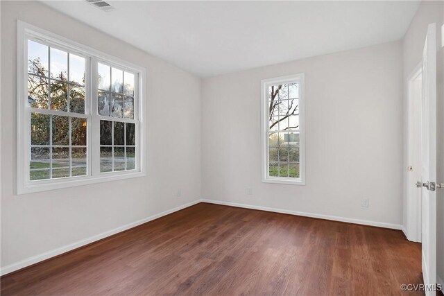 spare room with dark hardwood / wood-style floors