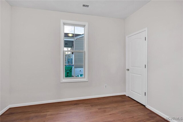 unfurnished room featuring dark hardwood / wood-style floors