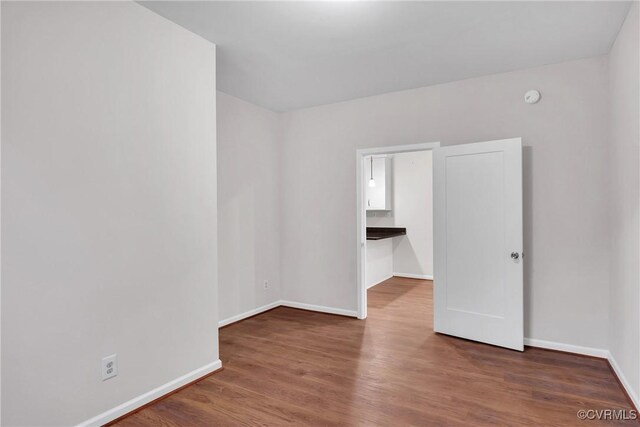 empty room featuring dark hardwood / wood-style flooring