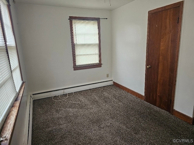 carpeted empty room featuring a baseboard radiator