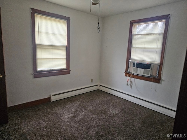 spare room with dark colored carpet, ceiling fan, cooling unit, and a baseboard heating unit