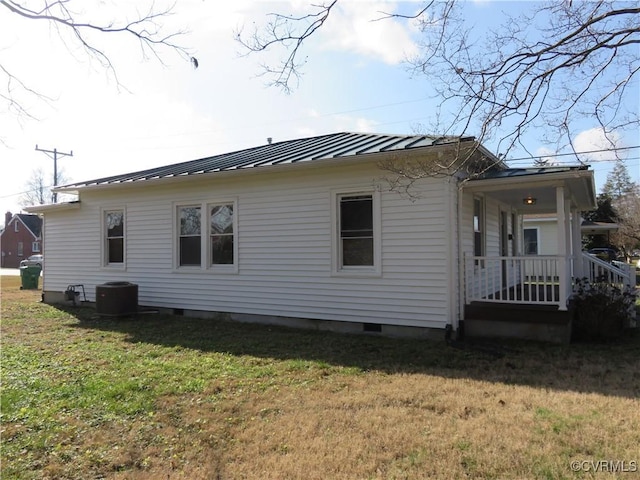 view of side of property with cooling unit and a yard