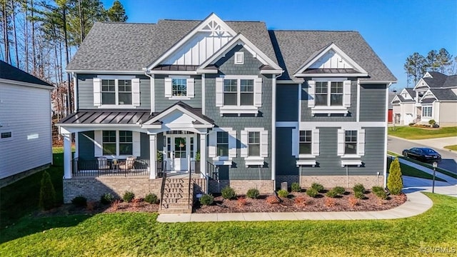 craftsman-style home featuring a front yard and covered porch