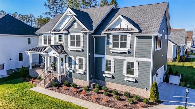 craftsman-style home with a garage and a front lawn