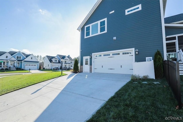 view of home's exterior with a garage and a lawn