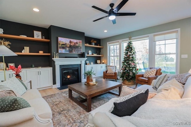 living room with light hardwood / wood-style floors and ceiling fan