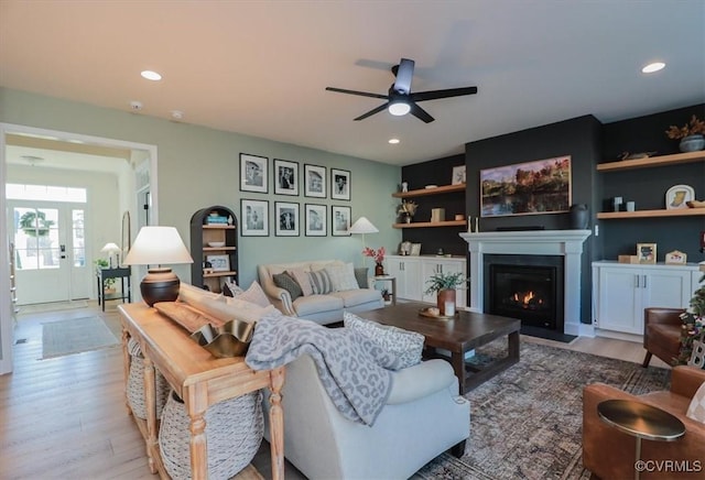 living room with light hardwood / wood-style floors and ceiling fan