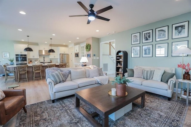 living room with dark hardwood / wood-style floors and ceiling fan