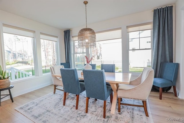 dining space with wood-type flooring