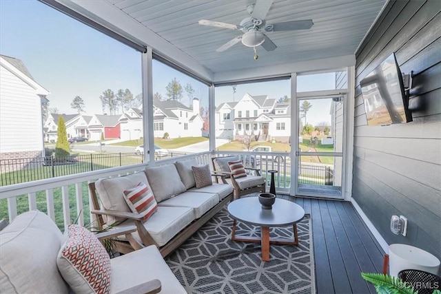 sunroom / solarium with ceiling fan, wooden ceiling, and a healthy amount of sunlight