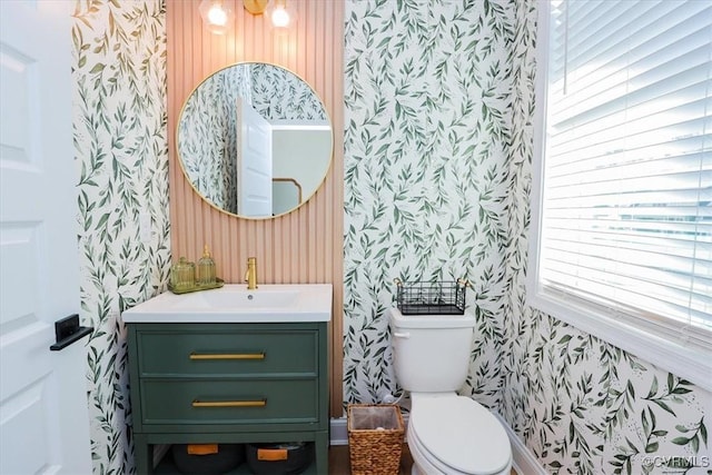 bathroom featuring vanity and toilet