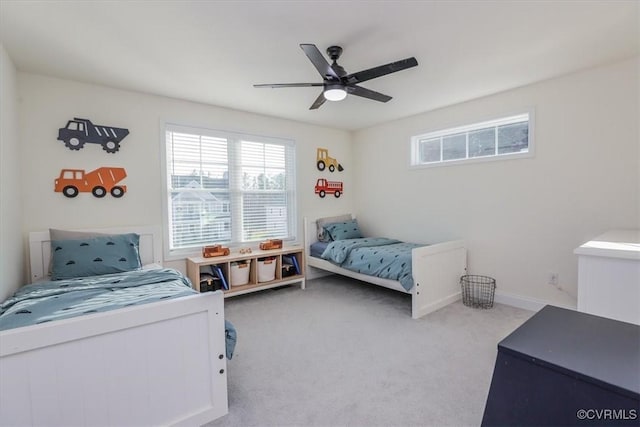 bedroom with ceiling fan and light carpet