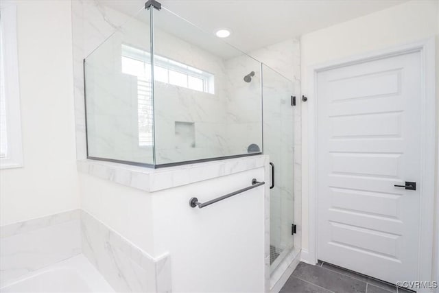 bathroom featuring tile patterned floors and plus walk in shower