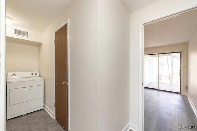 clothes washing area with light hardwood / wood-style flooring and washer / dryer