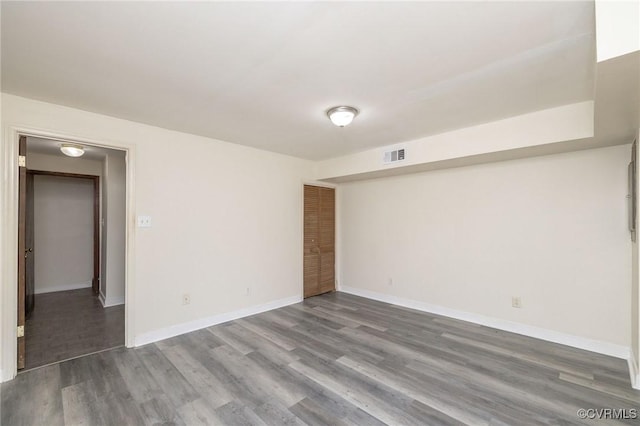 unfurnished room with wood-type flooring