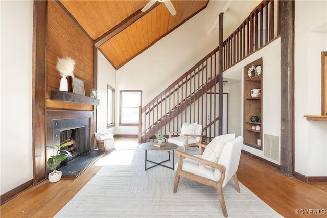 living room with high vaulted ceiling, wooden ceiling, and wood-type flooring