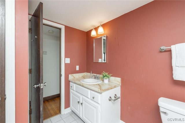 bathroom featuring toilet, vanity, and tile patterned floors