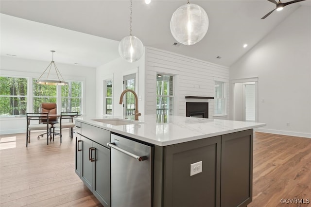 2219 Silver St, Aylett, VA 23009 - kitchen featuring stainless steel dishwasher, a fireplace, open floor plan, light wood finished floors, and high vaulted ceiling
