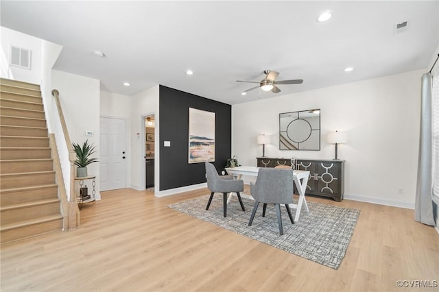 dining room with ceiling fan and light hardwood / wood-style flooring