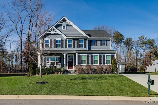 view of front of house with covered porch and a front yard