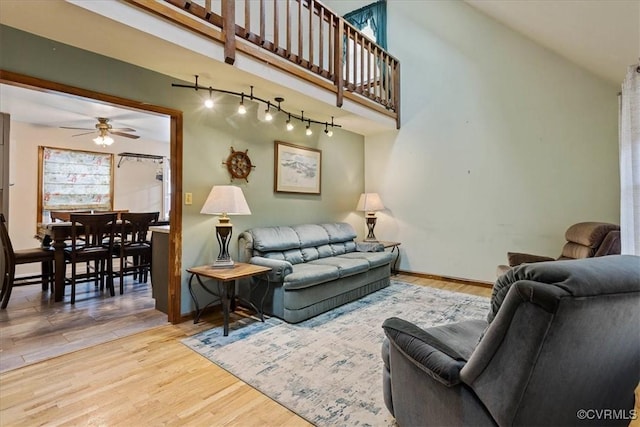 living room with ceiling fan and hardwood / wood-style floors