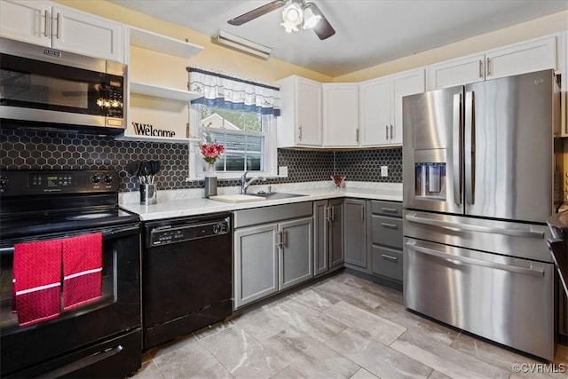 kitchen featuring white cabinets, sink, gray cabinetry, and black appliances