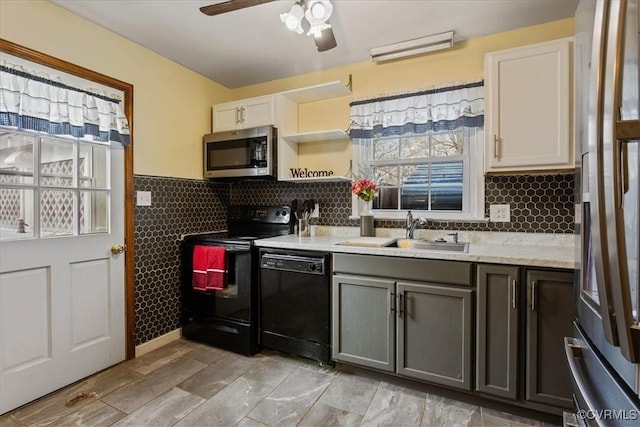 kitchen with gray cabinetry, ceiling fan, sink, black appliances, and white cabinets