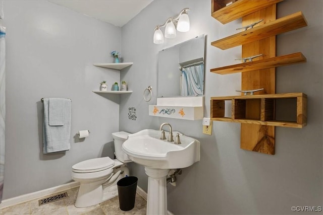 bathroom with sink and toilet