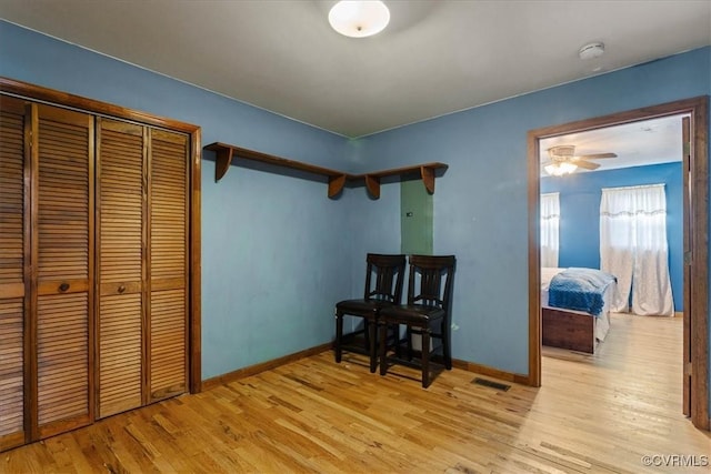 bedroom with light hardwood / wood-style floors and a closet