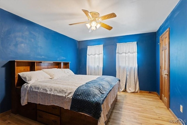 bedroom with light wood-type flooring and ceiling fan