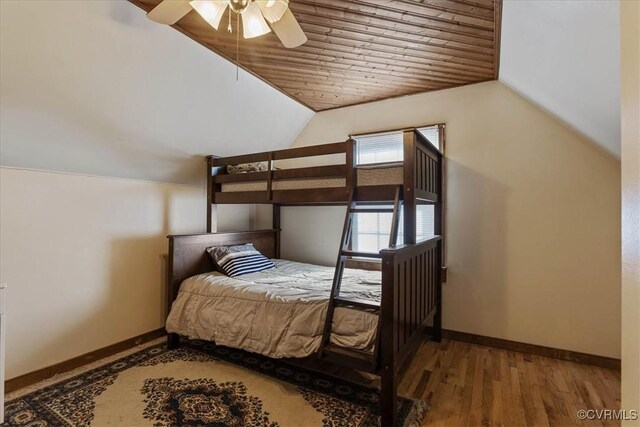 bedroom featuring wood-type flooring, vaulted ceiling, ceiling fan, and wood ceiling