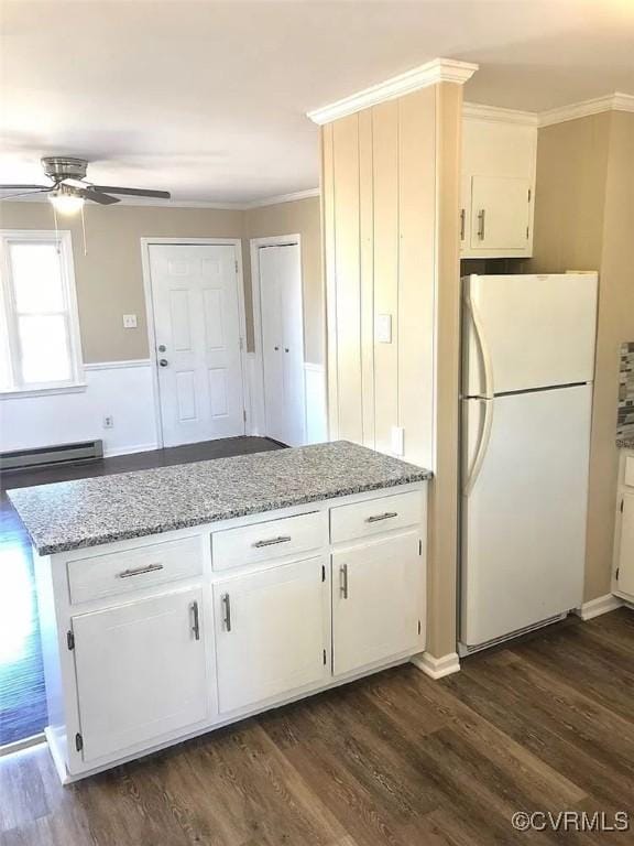 kitchen with white refrigerator, dark hardwood / wood-style floors, and white cabinetry