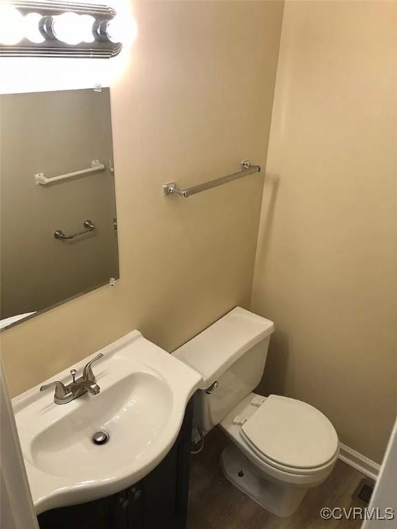 bathroom featuring hardwood / wood-style flooring, sink, and toilet