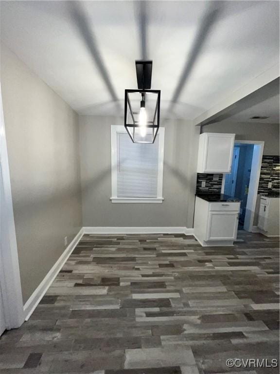 unfurnished dining area with dark hardwood / wood-style flooring