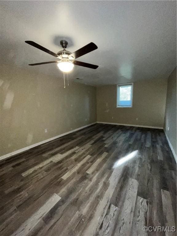 empty room featuring a textured ceiling and dark hardwood / wood-style floors