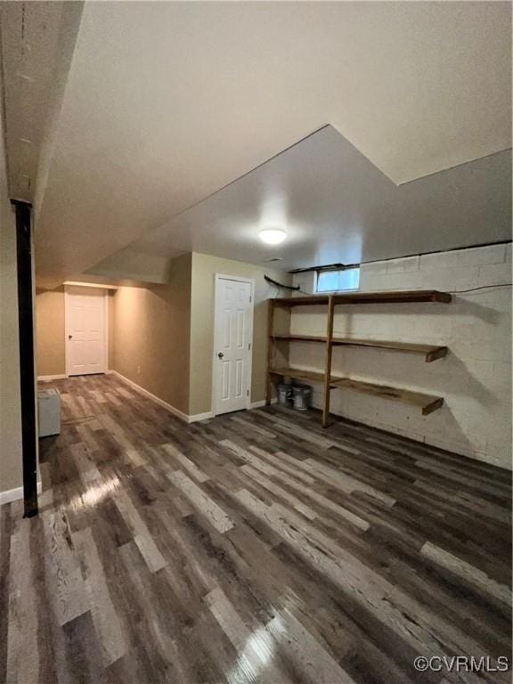 additional living space with dark hardwood / wood-style flooring