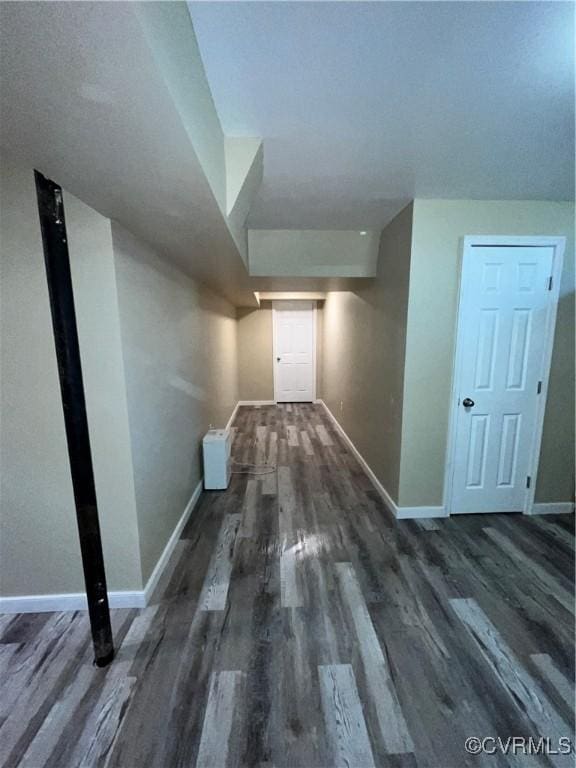 hall with dark hardwood / wood-style flooring and vaulted ceiling