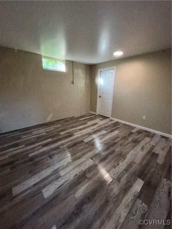 basement with a textured ceiling and dark wood-type flooring